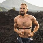 Happy man with beard running outdoors and smiling